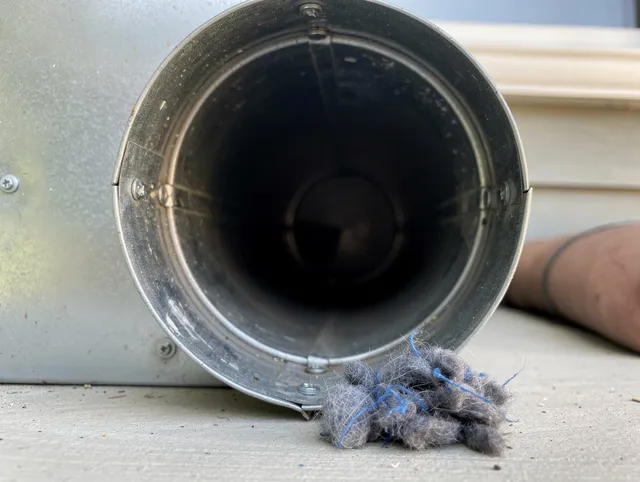 Sierra Madre Dryer Vent Cleaning technician using specialized equipment to clear severe dryer vent blockage in Sierra Madre